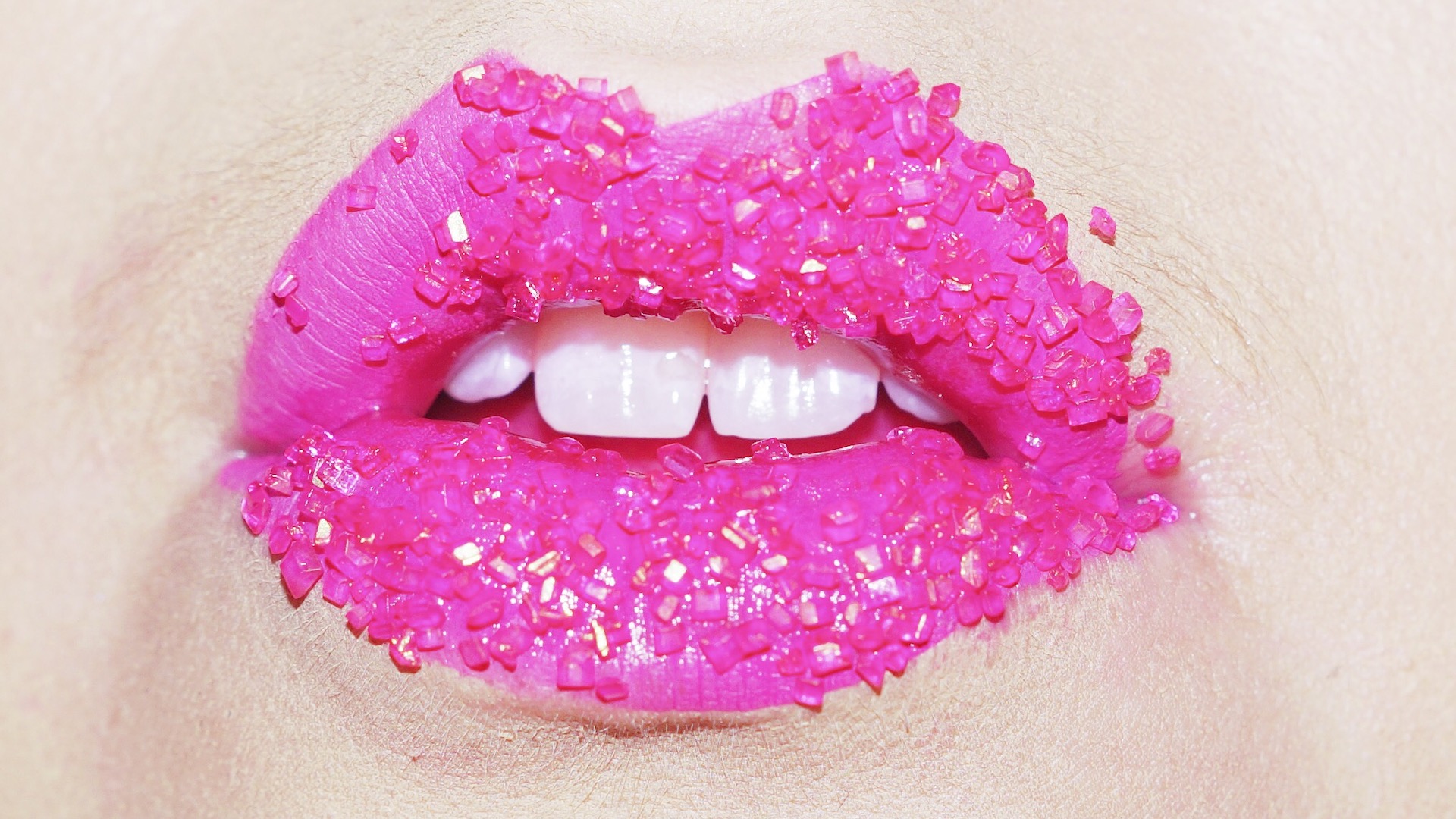 Bright pink lips with jewels on top