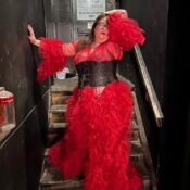 Image of Madam Ode'Miin Surprise in a red dress and black corset