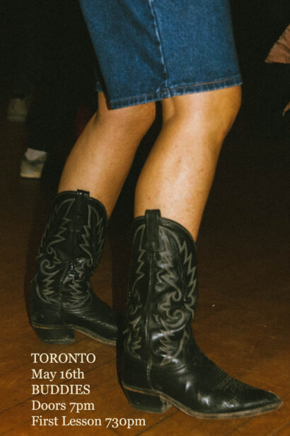 A photo of a pair of legs wearing denim shorts and black cowboy boots. The text in the lower left corner reads: " Toronto. May sixteenth. Buddies. Doors seven pm. First lesson seven thirty pm.