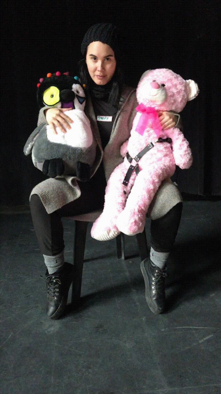 Artist holding two kinky stuffed animals